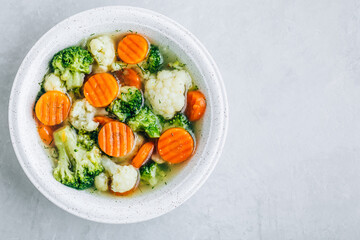 Vegetable soup. Spring broccoli, cauliflower, carrots soup in bowl.