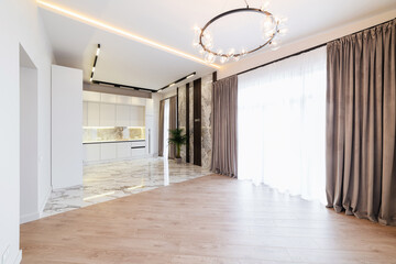 new interior of a white kitchen with a large window in the room