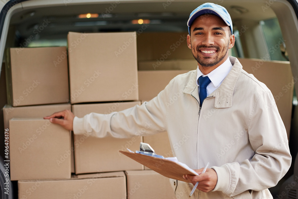 Poster service with a smile. portrait of a friendly delivery man standing next to a van full of boxes.
