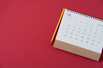close up of calendar and pencil on the red table background, planning for business meeting or...