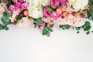 Floral white background with copy space. Roses, eucalyptus, hydrangea, tulips. Spring flowers.