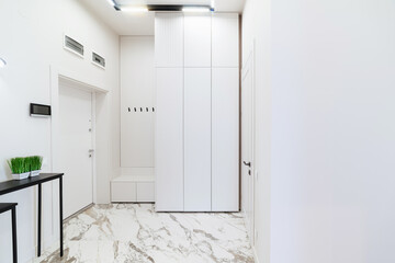 white interior corridor in a house with white doors and closet