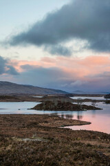Beautiful vibrant Winter sunrise landscape image across Rannoch Moor in Scottish Highlands