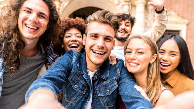 Happy tourists group taking selfie photo walking in european city street - Multiracial young people smiling together at camera outside - University students enjoying day out in college campus