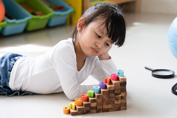 Asian 4 years old feeling bored while she play alone at home, concept of social skill, friendship...