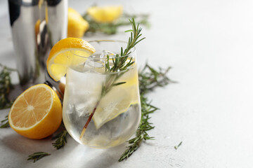 Refreshing drink with natural ice, lemon, and rosemary.