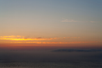 Fototapeta na wymiar fog over the sea after sunset