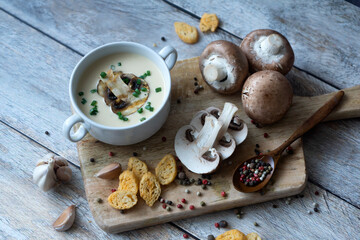 Fragrant champignon puree soup on a wooden table.