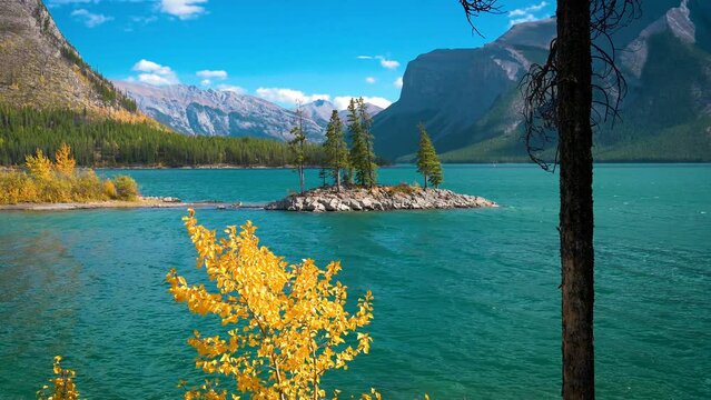 Small island with trees on Lake Minnewanka in Banff National Park, Canada