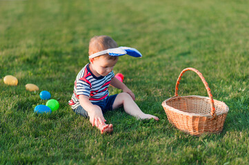 Toddler eggs hunters close-up. Children activity for Easter in nature..