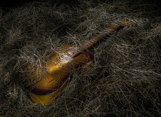 Acoustic guitar on the hay. Musical vintage concept. Without people.