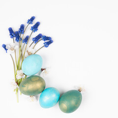 Easter eggs with flowers on white. Happy Easter concept. White and blue eggs isolated on white