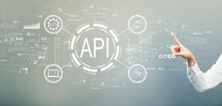 API - application programming interface concept with hand pressing a button on a gray background