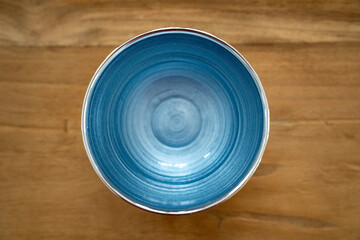 Blue silver italian glass bowl close up on wood