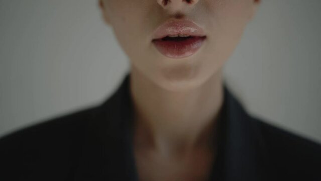 Young model woman in makeup. Girl with pink lipstick after beauty procedure. Fashion concept. Close up womans lips. Lip augmentation.