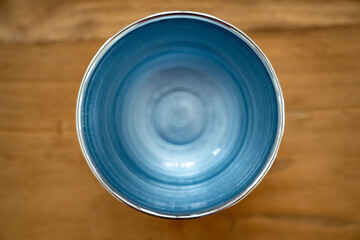 Blue silver italian glass bowl close up on wood