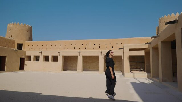 woman tourist visiting the ancient fortress of Al Zubarah at Qatar landmark