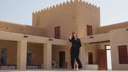 woman tourist visiting the ancient fortress of Al Zubarah at Qatar landmark
