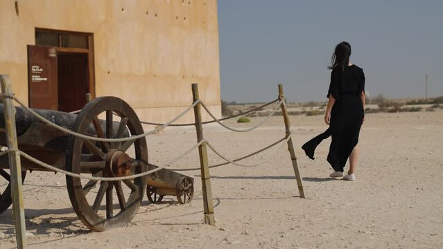 woman tourist visiting the ancient fortress of Al Zubarah at Qatar landmark
