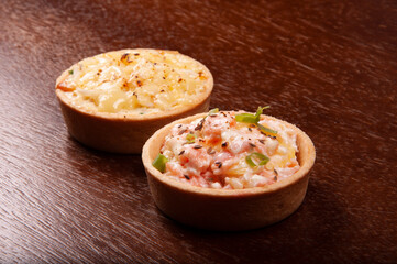 cheese pie and salmon pie close-up on wooden table