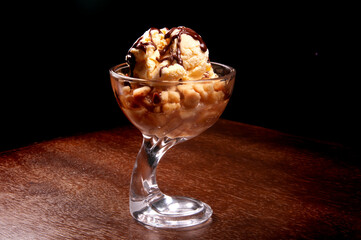 ice cream cup with apple pie and chocolate sauce on wooden table