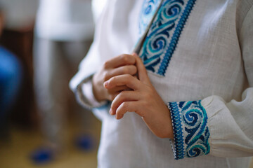 Child's hands. Child in anbroidered shirt. symbols of Ukraine