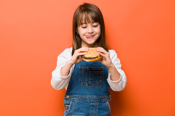 Cute little girl craving a cheeseburger