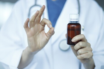 Doctor holding medicine healthcare syrup 