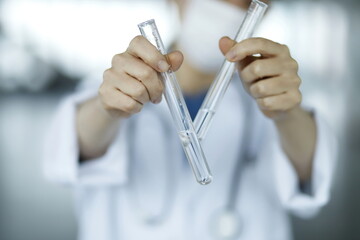 Close up of doctor holding test tubes. Biotechnology,medicine,chemistry concept