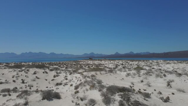 Island with Arid Sandy Terrain and Dry Vegetation. Aerial View