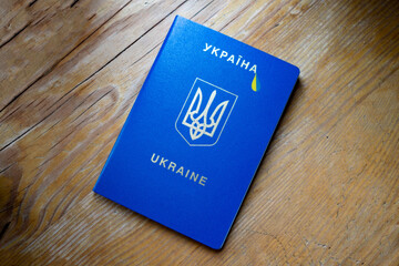 The inscription ukraine and the coat of arms of Ukraine on a blue background and a tear in the color of the ukrainian flag