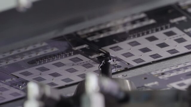 Selective soldering process. Automated machine with liquid solder. Manufacture of electronics in the factory close up. High tech.