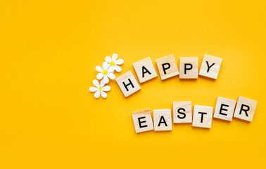 Easter composition. Easter eggs, decorative bunnies and decorations on a yellow background. Flat lay, top view, copy space