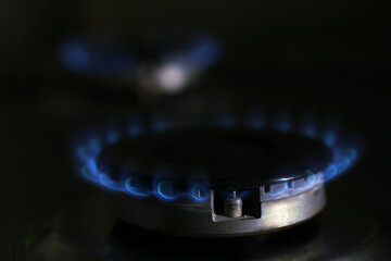 blue flame of burning gas in the kitchen stove