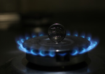 coin on the background of a burning gas flame