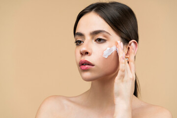 Moisturizing. Smiling girl. Skin care and beauty concept. Facial care for female. Keep skin...