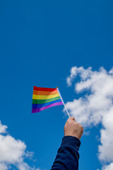 Holding gay pride symbol rainbow flag