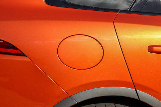 Oval fuel filler lid on a new orange car