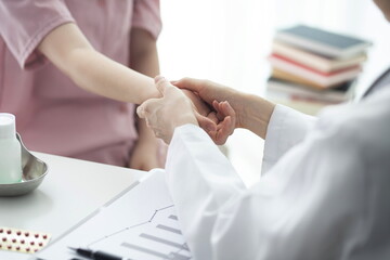 Doctor checking patient's hand pain - obrazy, fototapety, plakaty