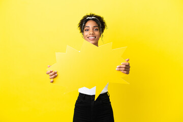 Young african american woman isolated on yellow background holding an empty speech bubble