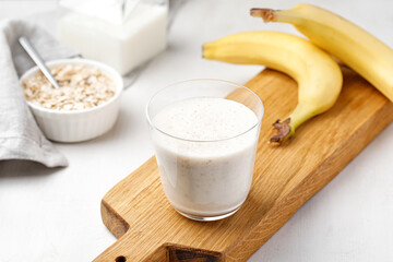 Milk cocktail with banana and oat. Banana smoothie. Milkshake with banana and oatmeal, healthy breakfast.