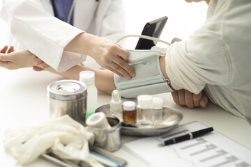 Doctor measuring blood pressure of patient. Medicine concept