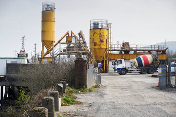 Cement mixing yellow towers and manufacturing site
