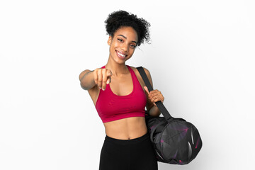 Fototapeta na wymiar Young sport african american woman with sport bag isolated on blue background pointing front with happy expression