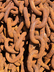 Large rusty metal chains on quay