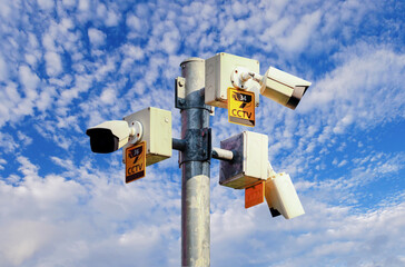 CCTV camera on bright blue sky background,  Concept. 24 hour day and night security
