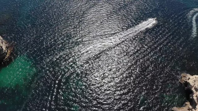 Aerial view of tourist boats in the bay of the rocky shore of the pure sea sea. Water tourism