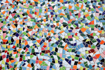 Closeup of ceramic mosaic with countless multicolored tiles with different shapes form a coherent...