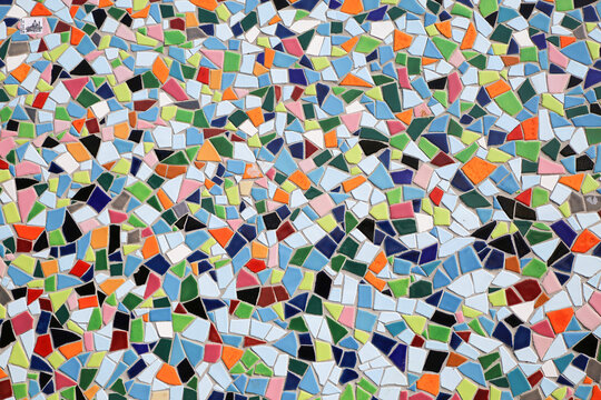 Closeup of ceramic mosaic with countless multicolored tiles with different shapes form a coherent overall picture seamless background
