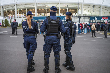 Policemen in front of the stadium before football match. - obrazy, fototapety, plakaty